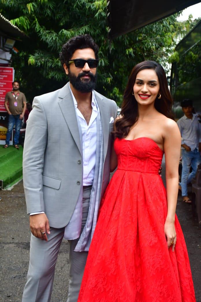 Vicky donned a dapper grey suit, and Manushi looked striking in a red dress.